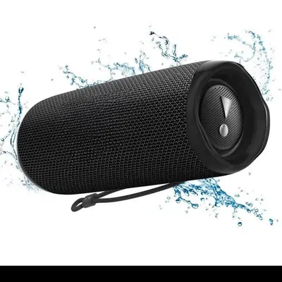 A black cylindrical portable speaker photographed with a splash of water on white