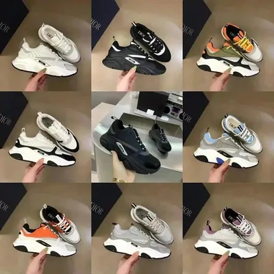 Nine chunky sneakers in white, grey, black and orange, each held up by hand against a white background